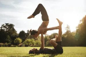 couple doing yoga outside during the sunrise.