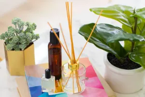 5 Diffuser sticks inside a clear jar sitting on top of a table. 