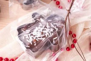 Christmas ginger bread shaped fudge inside cookie cutter wrapped in clear plastic. 