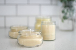 Four Beeswax candles in a glass jar.